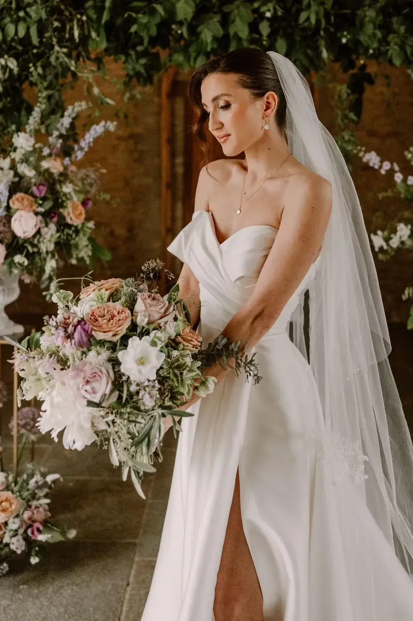 Bride with romantic hair and soft glam makeup by Jodie Elleanor